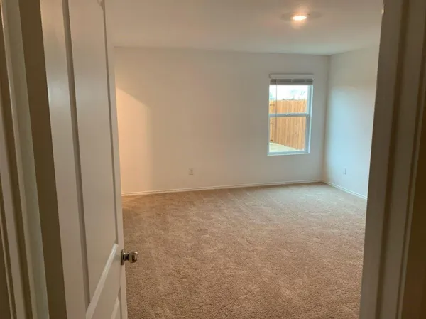 a view of an empty room and a window