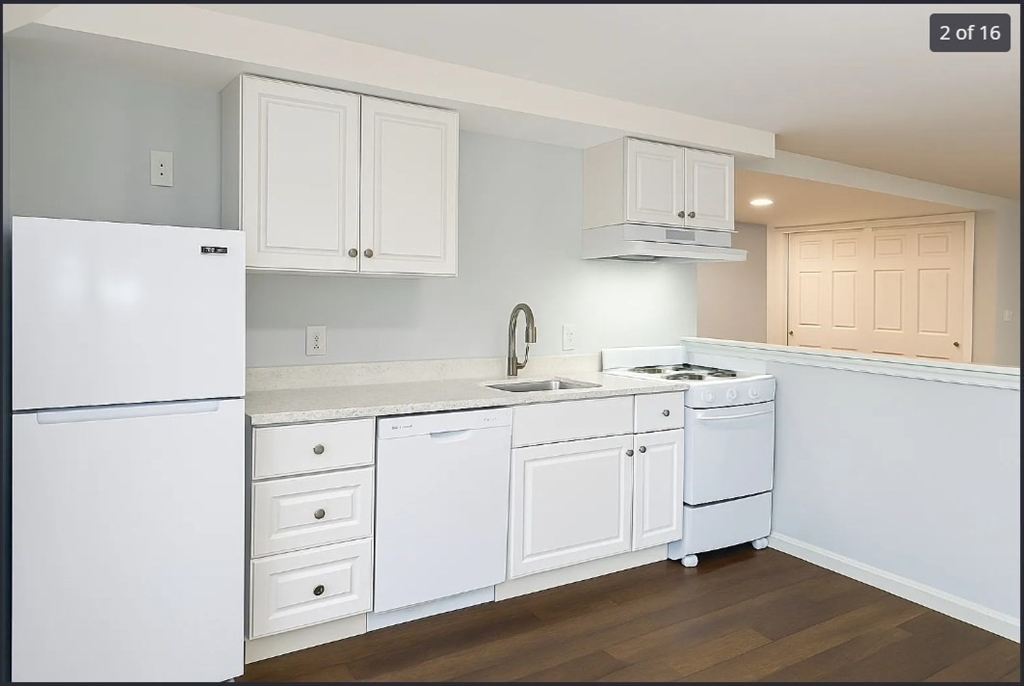 9 Avon Place, Unit 1 Haverhill, MA 01832 - Photo 2 of 16 a kitchen with cabinets appliances a sink and a window