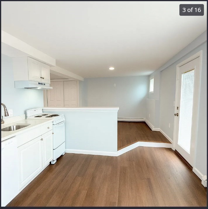 9 Avon Place, Unit 1 Haverhill, MA 01832 - Photo 3 of 16 a view of a kitchen with wooden floor and electronic appliances