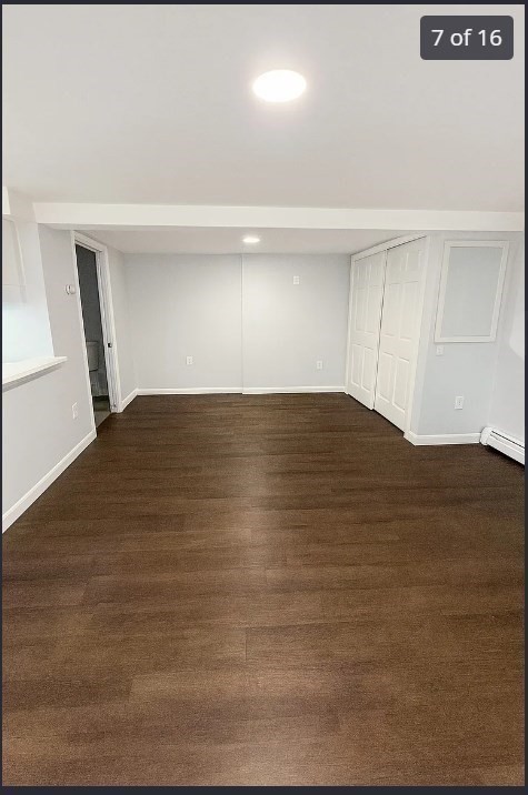 9 Avon Place, Unit 1 Haverhill, MA 01832 - Photo 7 of 16 a view of an empty room with wooden floor