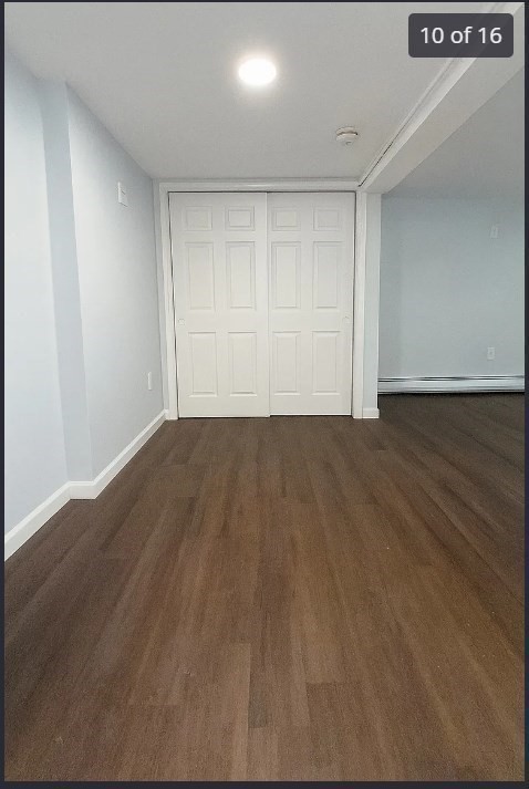 9 Avon Place, Unit 1 Haverhill, MA 01832 - Photo 10 of 16 a view of an empty room with wooden floor