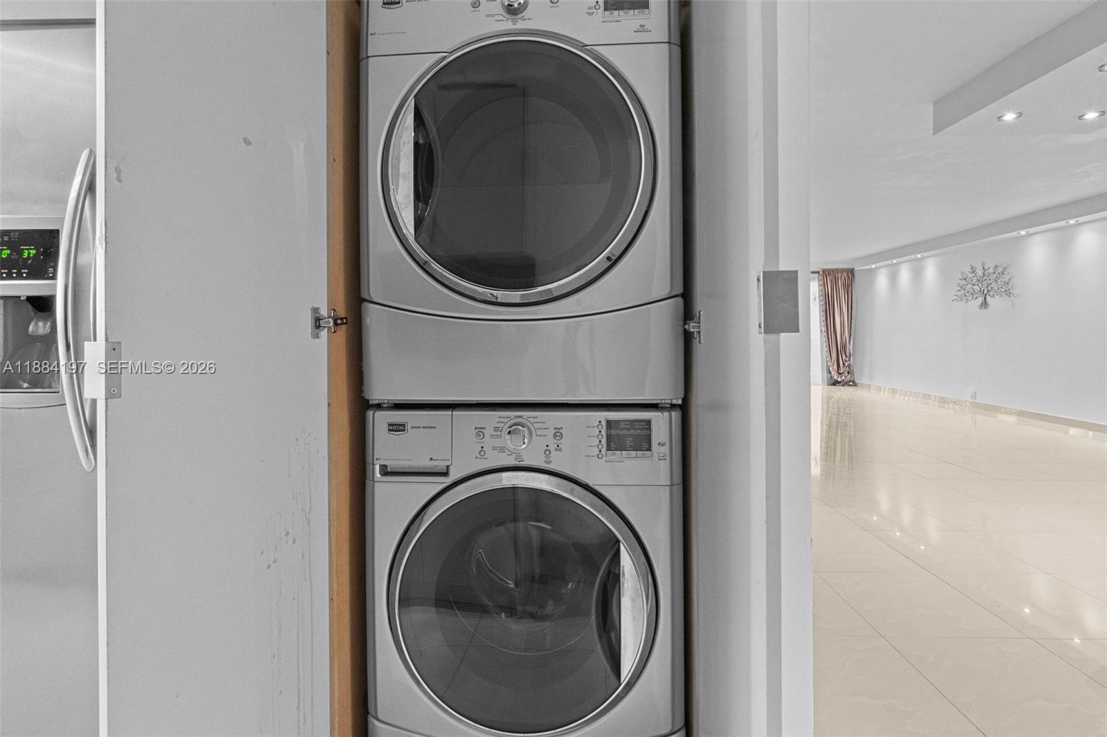 1750 Northeast 191st Street, Unit 7001 Miami, FL 33179 - Photo 19 of 30 a utility room with dryer and washer