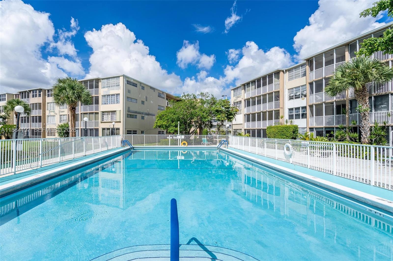 1750 Northeast 191st Street, Unit 7001 Miami, FL 33179 - Photo 23 of 30 a view of a swimming pool with a porch