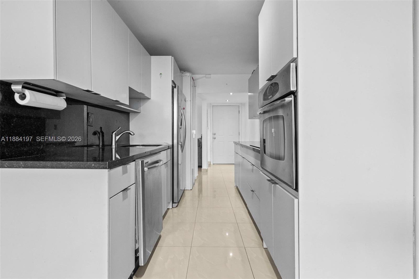 1750 Northeast 191st Street, Unit 7001 Miami, FL 33179 - Photo 9 of 30 a kitchen with stainless steel appliances a refrigerator and a stove