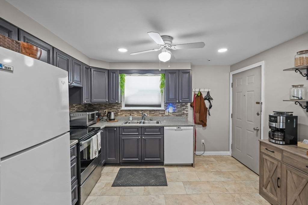 172 Perry Avenue, Unit 1A Worcester, MA 01610 - Photo 20 of 26 a kitchen with a sink stainless steel appliances and cabinets