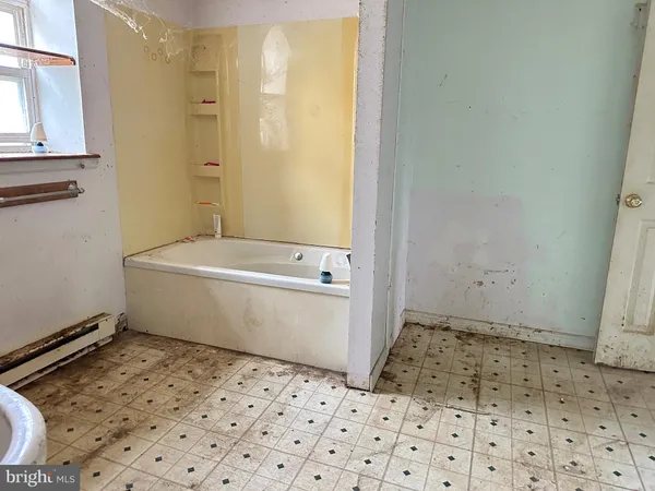 a bathroom with a sink a toilet and a window