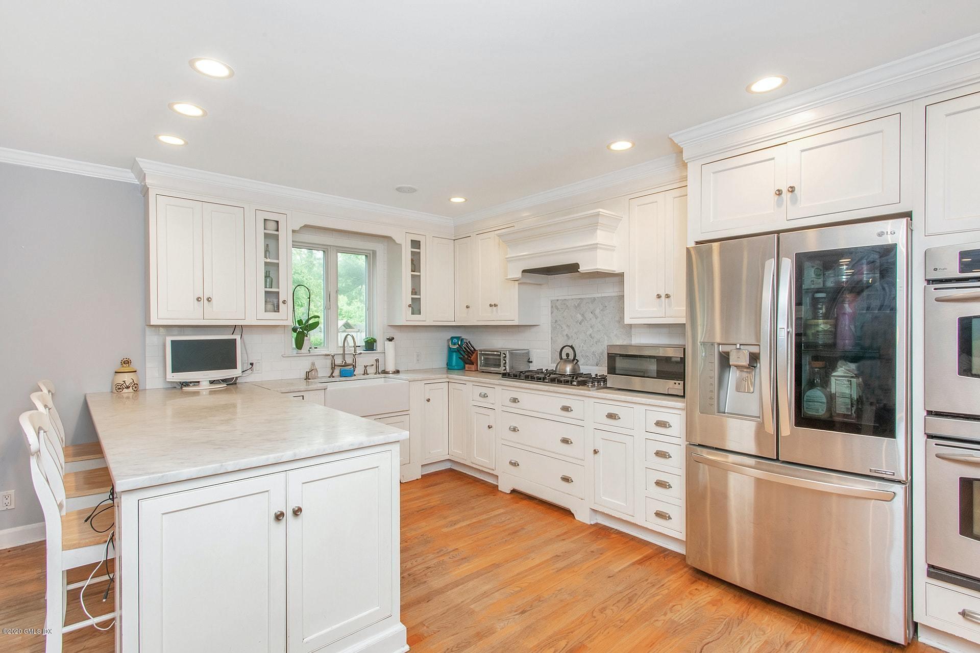 67 Summit Road Riverside, CT 06878 - Photo 8 of 33 a kitchen with stainless steel appliances a refrigerator sink and cabinets