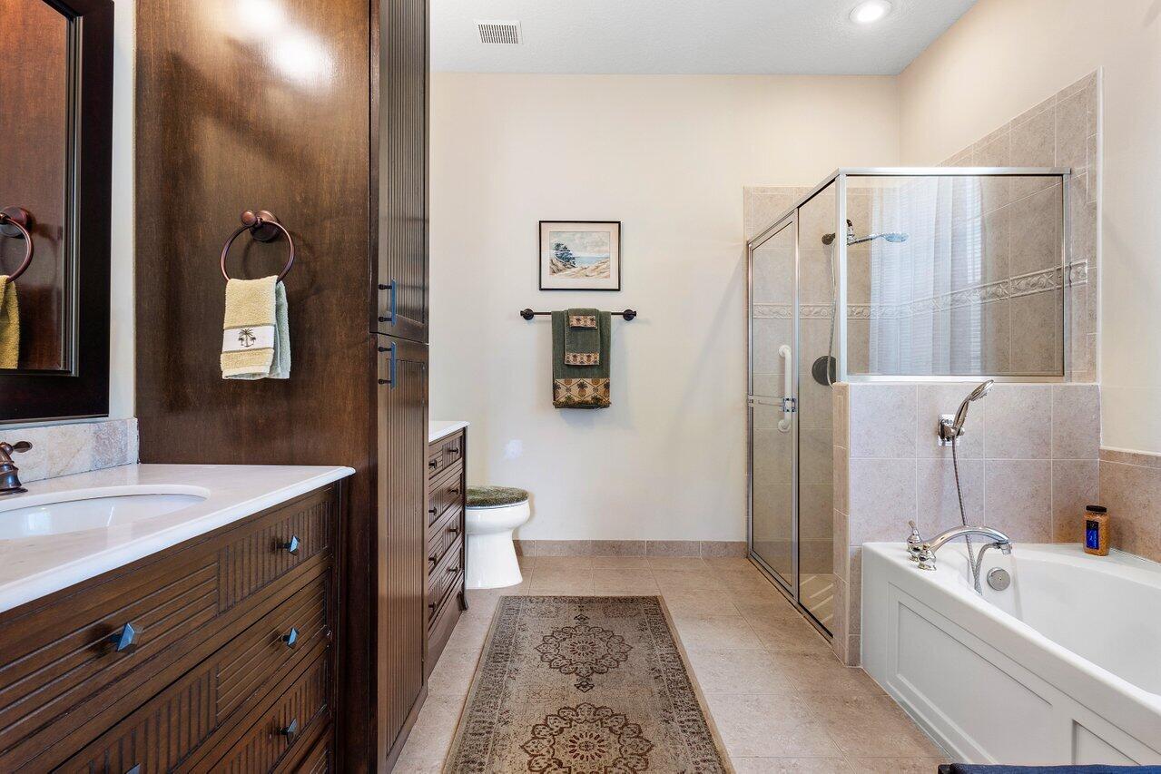 142 Mangrove Bay Way Jupiter, FL 33477 - Photo 11 of 17 a bathroom with a tub sink and mirror