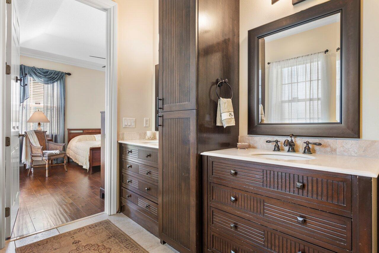 142 Mangrove Bay Way Jupiter, FL 33477 - Photo 12 of 17 a bathroom with a sink a mirror and a bathtub