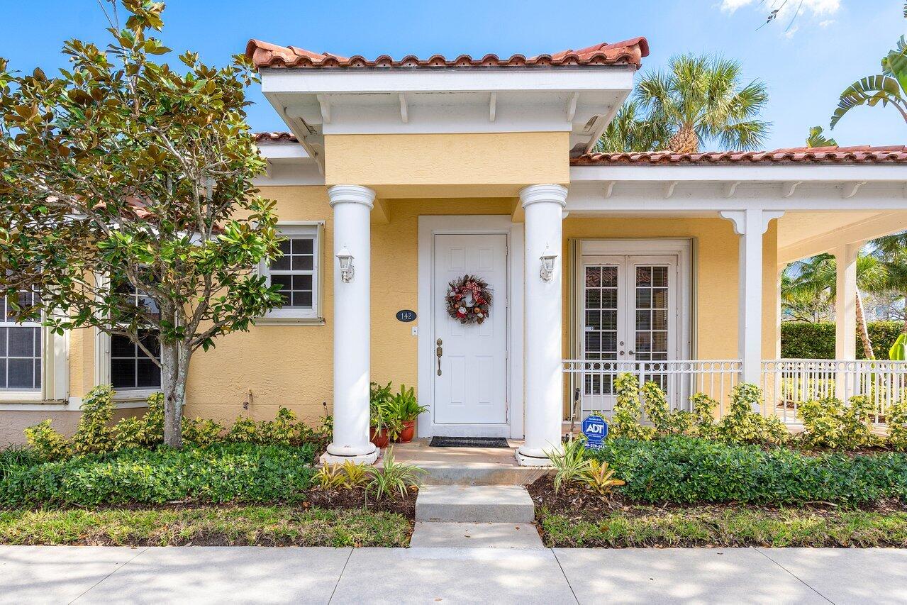 142 Mangrove Bay Way Jupiter, FL 33477 - Photo 2 of 17 front view of a house with potted plants