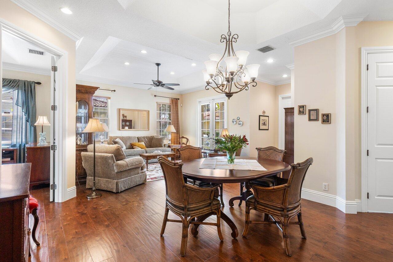 142 Mangrove Bay Way Jupiter, FL 33477 - Photo 4 of 17 a view of a dining room with furniture and wooden floor