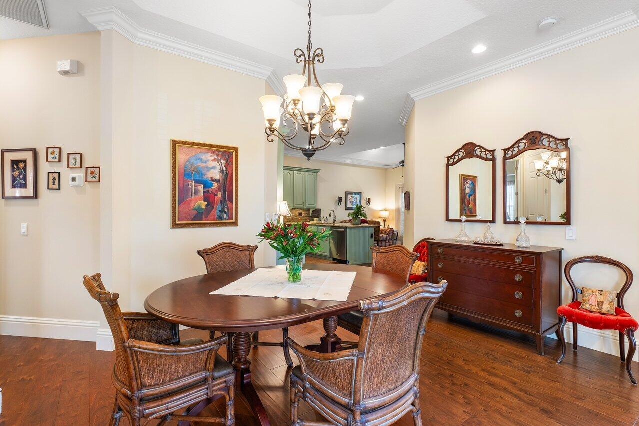 142 Mangrove Bay Way Jupiter, FL 33477 - Photo 5 of 17 a view of a dining room with furniture and chandelier