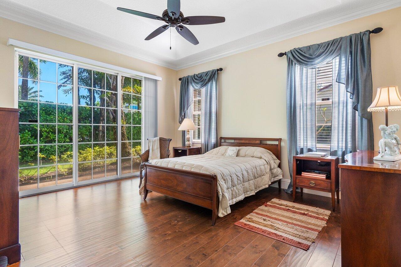 142 Mangrove Bay Way Jupiter, FL 33477 - Photo 10 of 17 a bedroom with a large bed and a large window