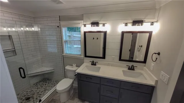 a bathroom with double sink and mirror