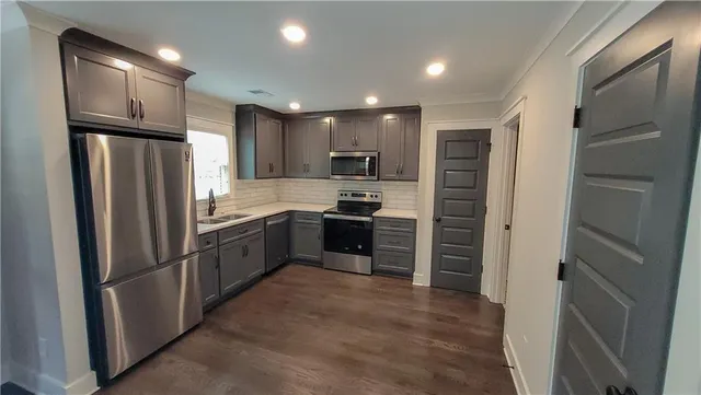 a kitchen with a refrigerator and a sink