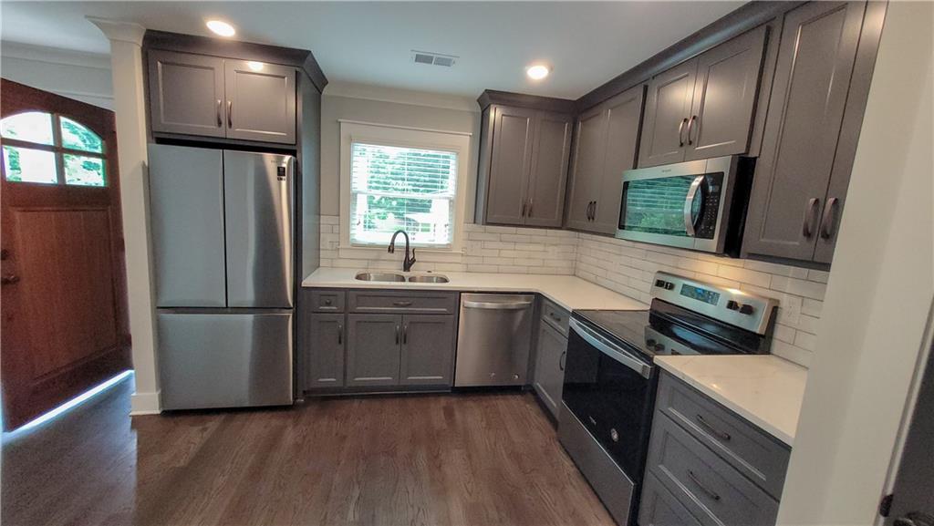 110 Strippling Street Ball Ground, GA 30107 - Photo 4 of 13 a kitchen with a refrigerator stove and sink
