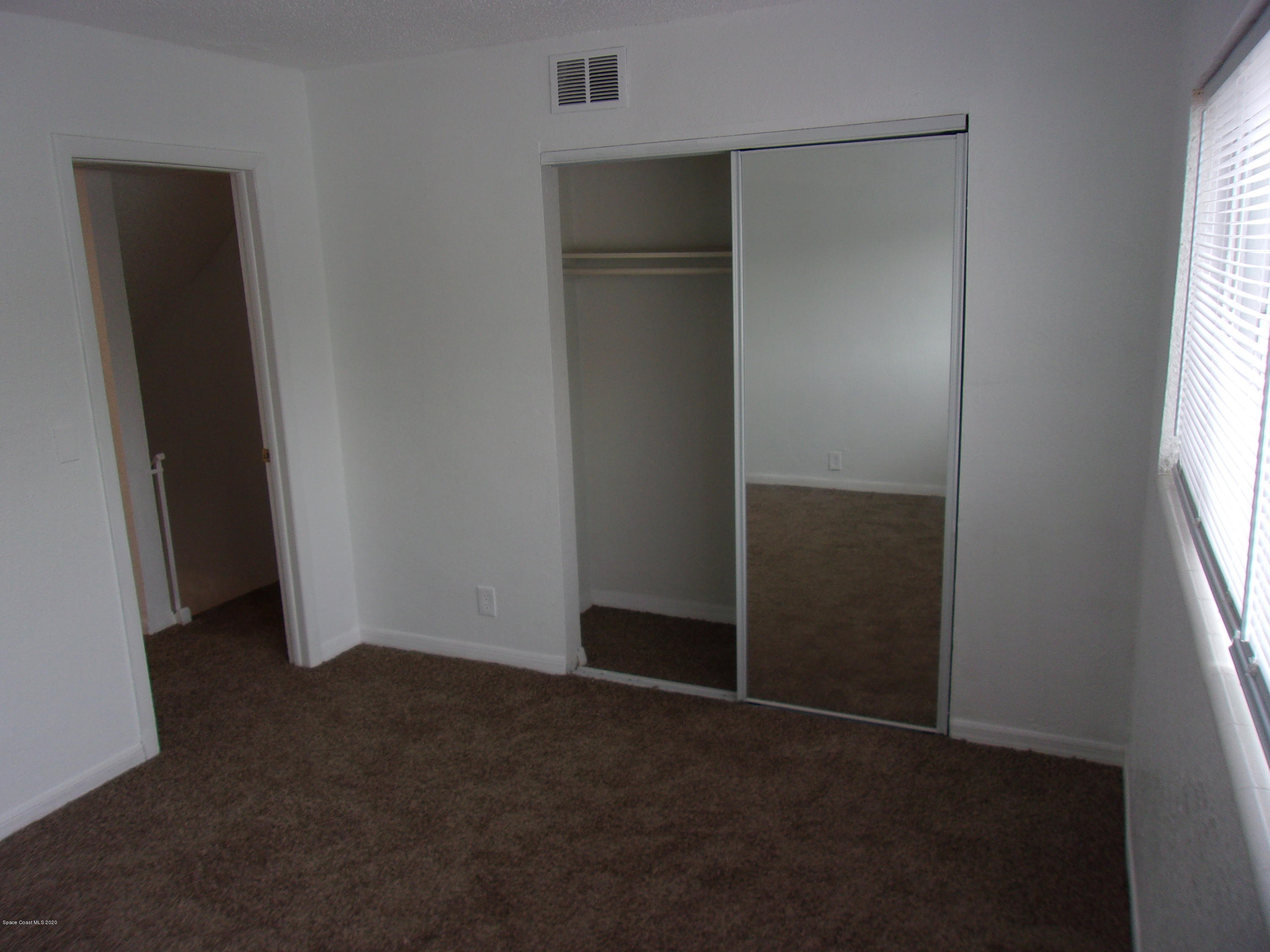 1711 Dixon Boulevard, Unit 242 Cocoa, FL 32922 - Photo 20 of 26 an empty room with windows and closet
