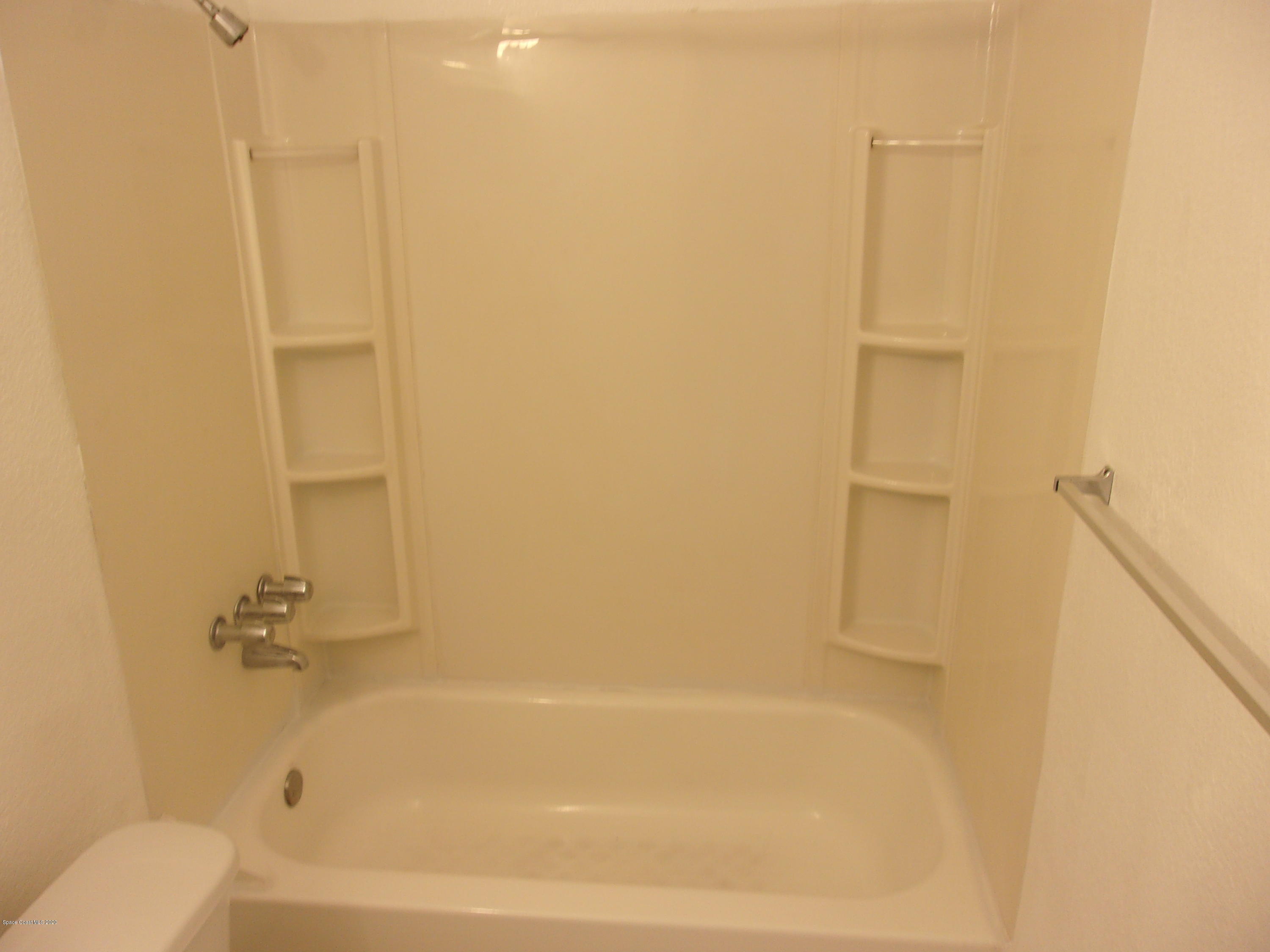 1711 Dixon Boulevard, Unit 242 Cocoa, FL 32922 - Photo 26 of 26 a bathroom with a bathtub