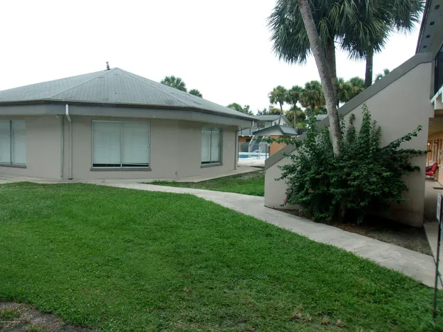 a front view of a house with a garden and yard