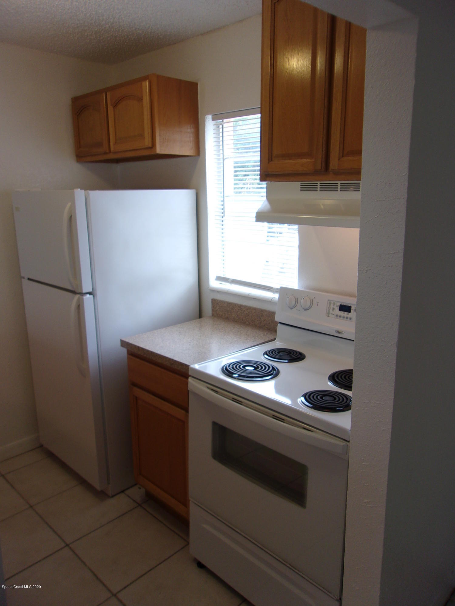 1711 Dixon Boulevard, Unit 242 Cocoa, FL 32922 - Photo 8 of 26 a kitchen with a stove and a refrigerator