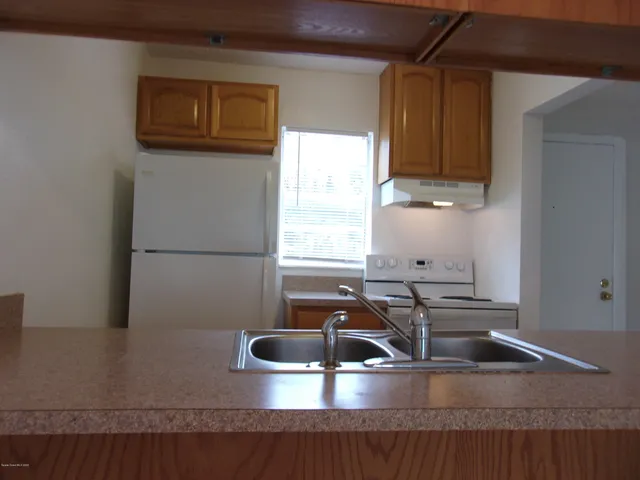 a kitchen with a sink and a stove top oven