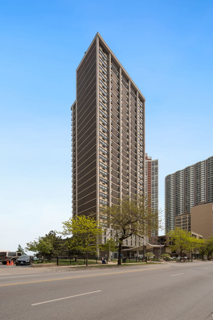 a view of a tall building next to a road