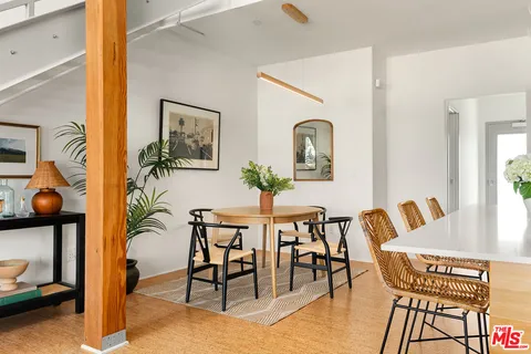 a view of a dining room with furniture and a potted plant