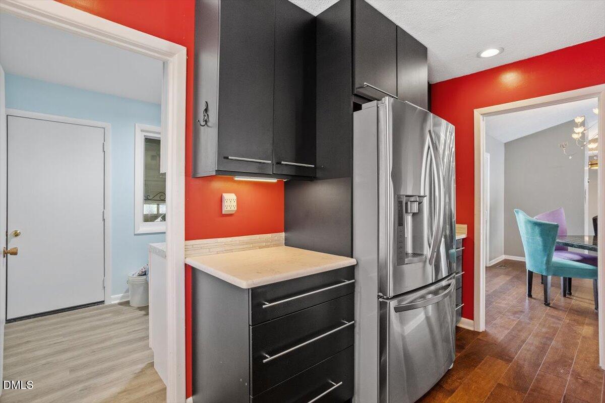 4501 Wingate Drive Raleigh, NC 27609 - Photo 11 of 36 a kitchen with stainless steel appliances a refrigerator and wooden floor