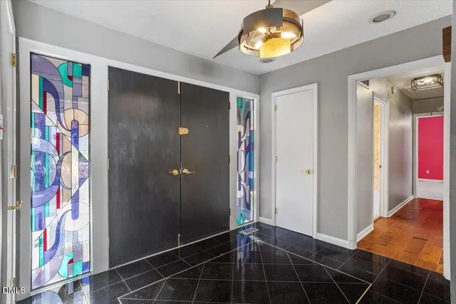 a view of an entryway with a chandelier fan