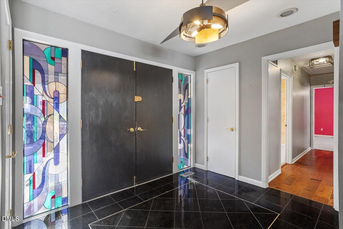 4501 Wingate Drive Raleigh, NC 27609 - Photo 18 of 36 a view of an entryway with a chandelier fan