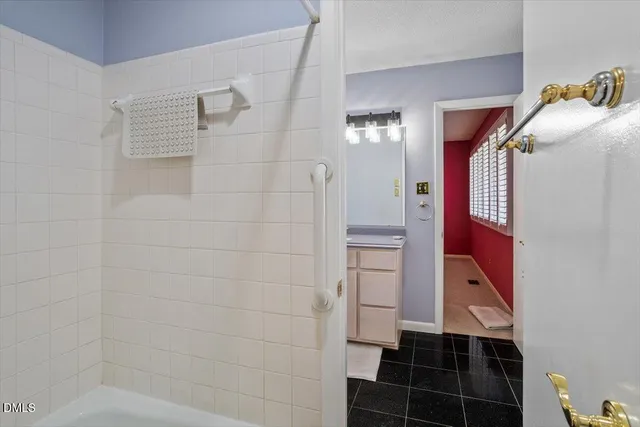 a bathroom with a bathtub and shower