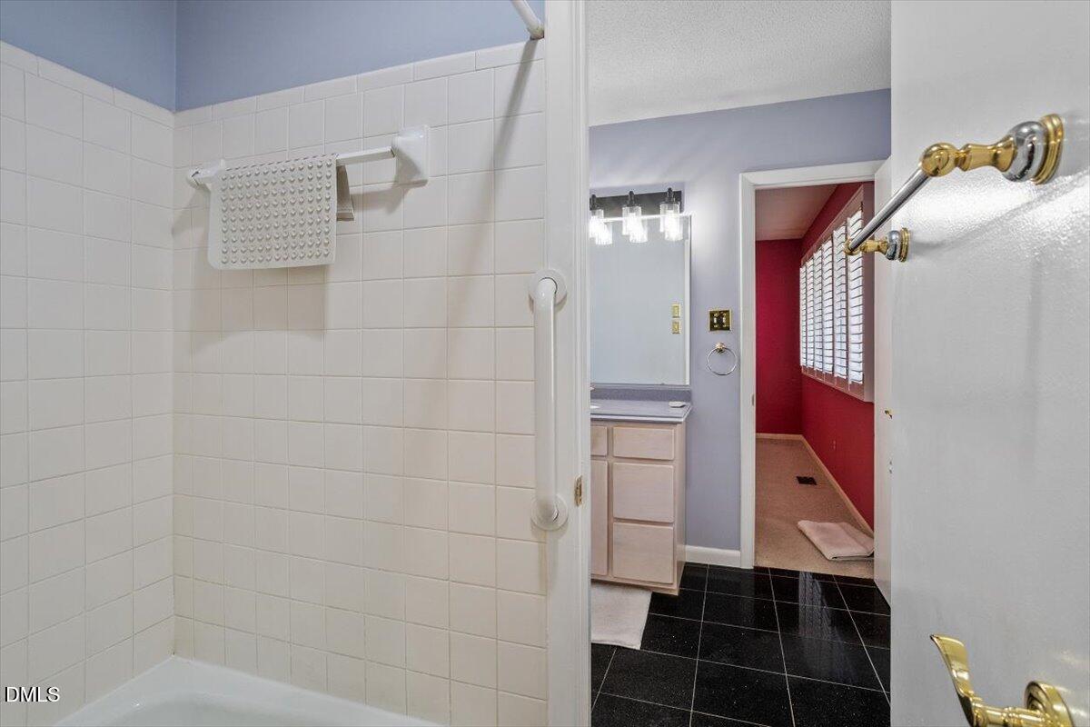 4501 Wingate Drive Raleigh, NC 27609 - Photo 22 of 36 a bathroom with a bathtub and shower