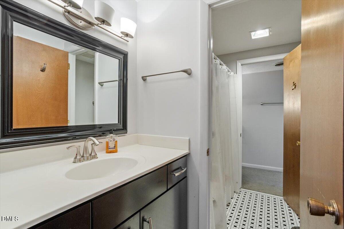 4501 Wingate Drive Raleigh, NC 27609 - Photo 27 of 36 a bathroom with a sink and a mirror