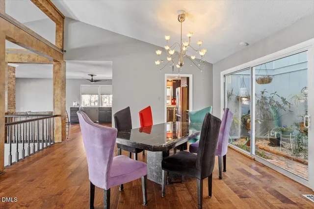 a view of a dining room with furniture wooden floor and chandelier