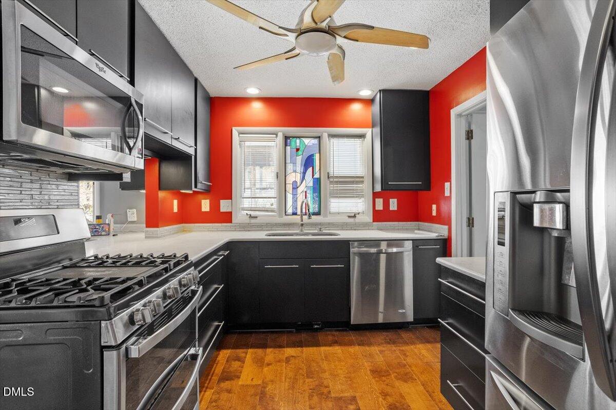 4501 Wingate Drive Raleigh, NC 27609 - Photo 9 of 36 a kitchen with stainless steel appliances granite countertop a stove and a sink