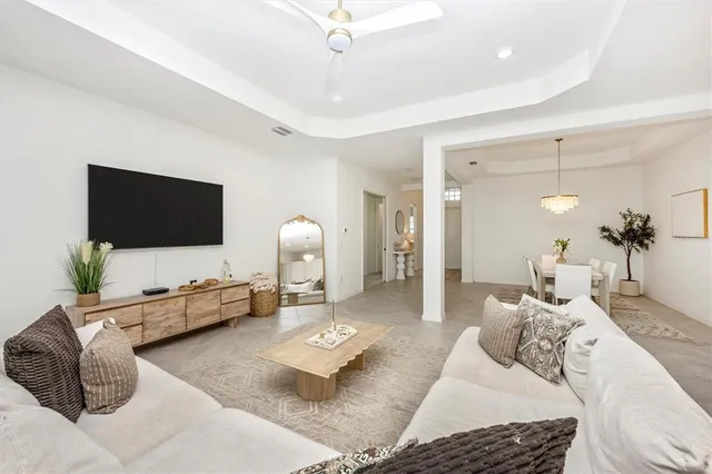 a bedroom with a bed and a flat screen tv on the dresser