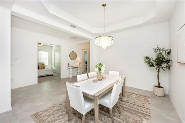 a kitchen with stainless steel appliances white cabinets and a refrigerator