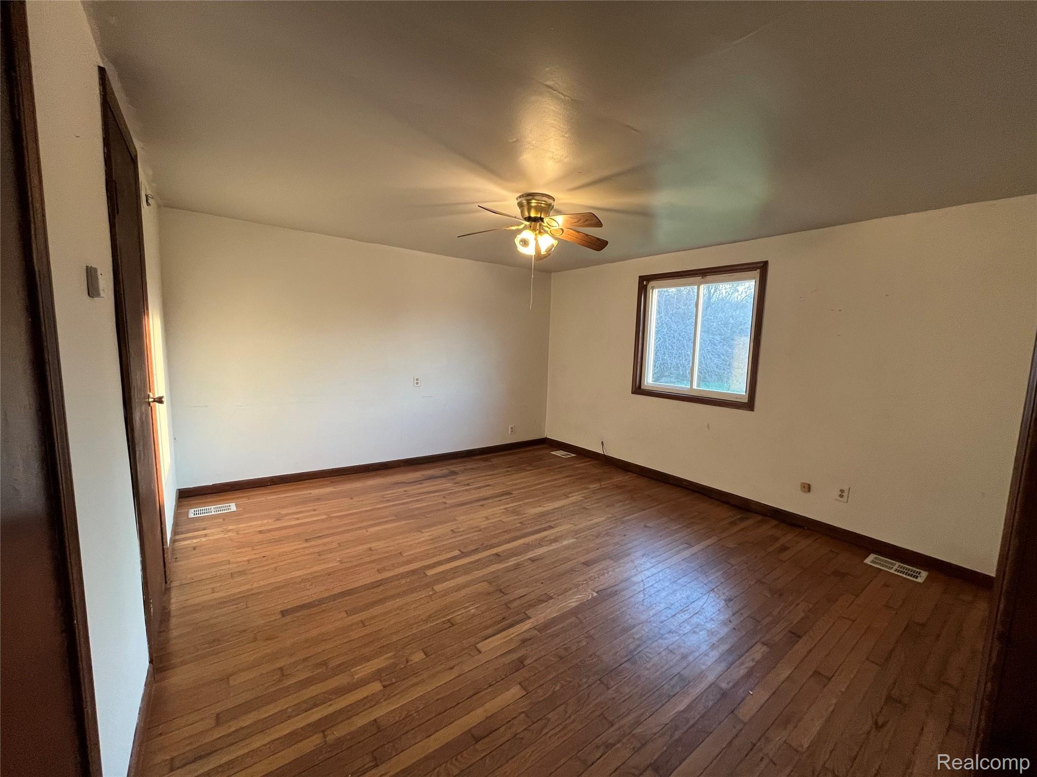 4218 Babcock Road, Unit 1 Croswell, MI 48422 - Photo 10 of 44 Unfurnished room with dark wood finished floors and a ceiling fan