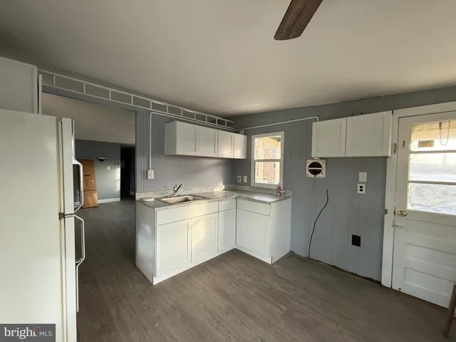 a kitchen with stainless steel appliances a refrigerator and a stove top oven