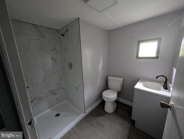 a bathroom with a toilet sink and shower
