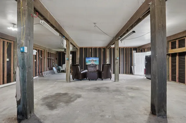 a view of a livingroom with furniture and the hallway