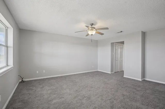 a view of a living room and floor to ceiling window or wooden floor
