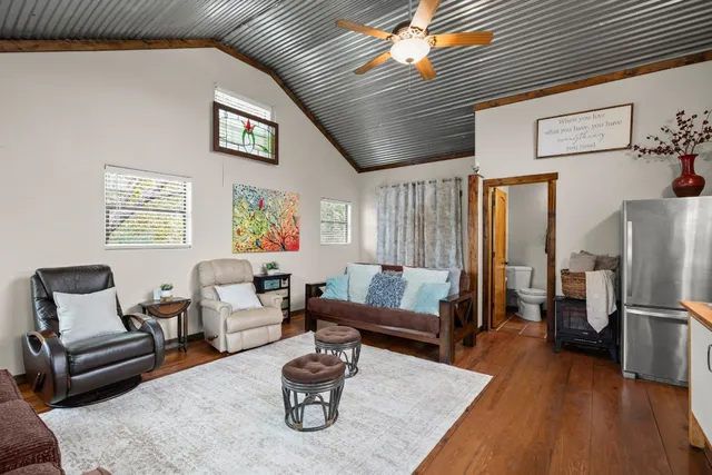 a living room with furniture and wooden floor