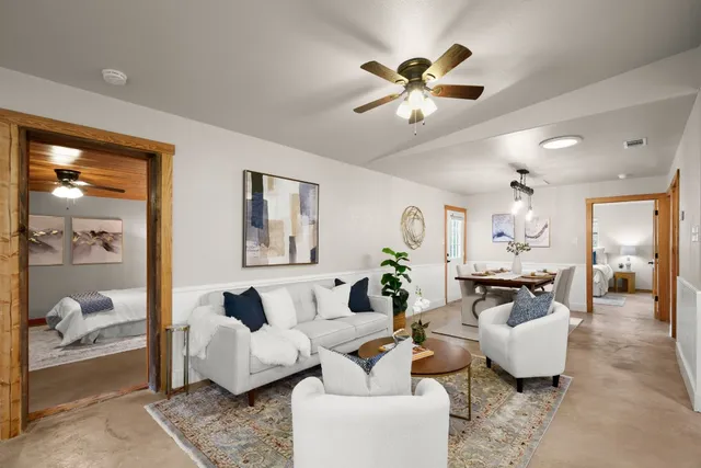 a living room with furniture and a large mirror
