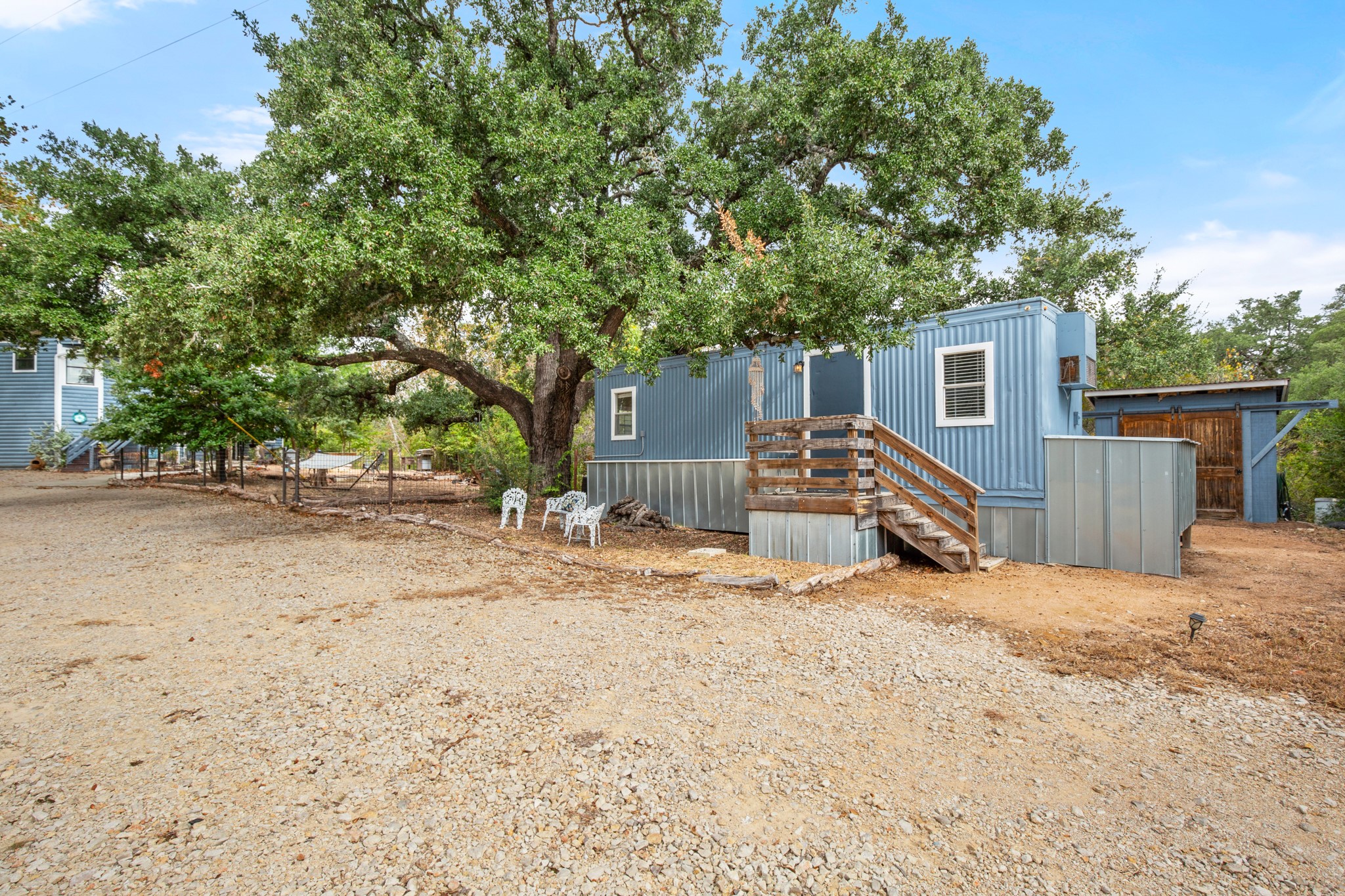 235 Smith Creek Road Wimberley, TX 78676 - Photo 31 of 40 a view of a house with a yard and garage