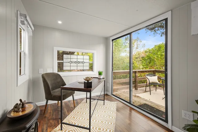 a view of balcony with wooden floor and outdoor seating