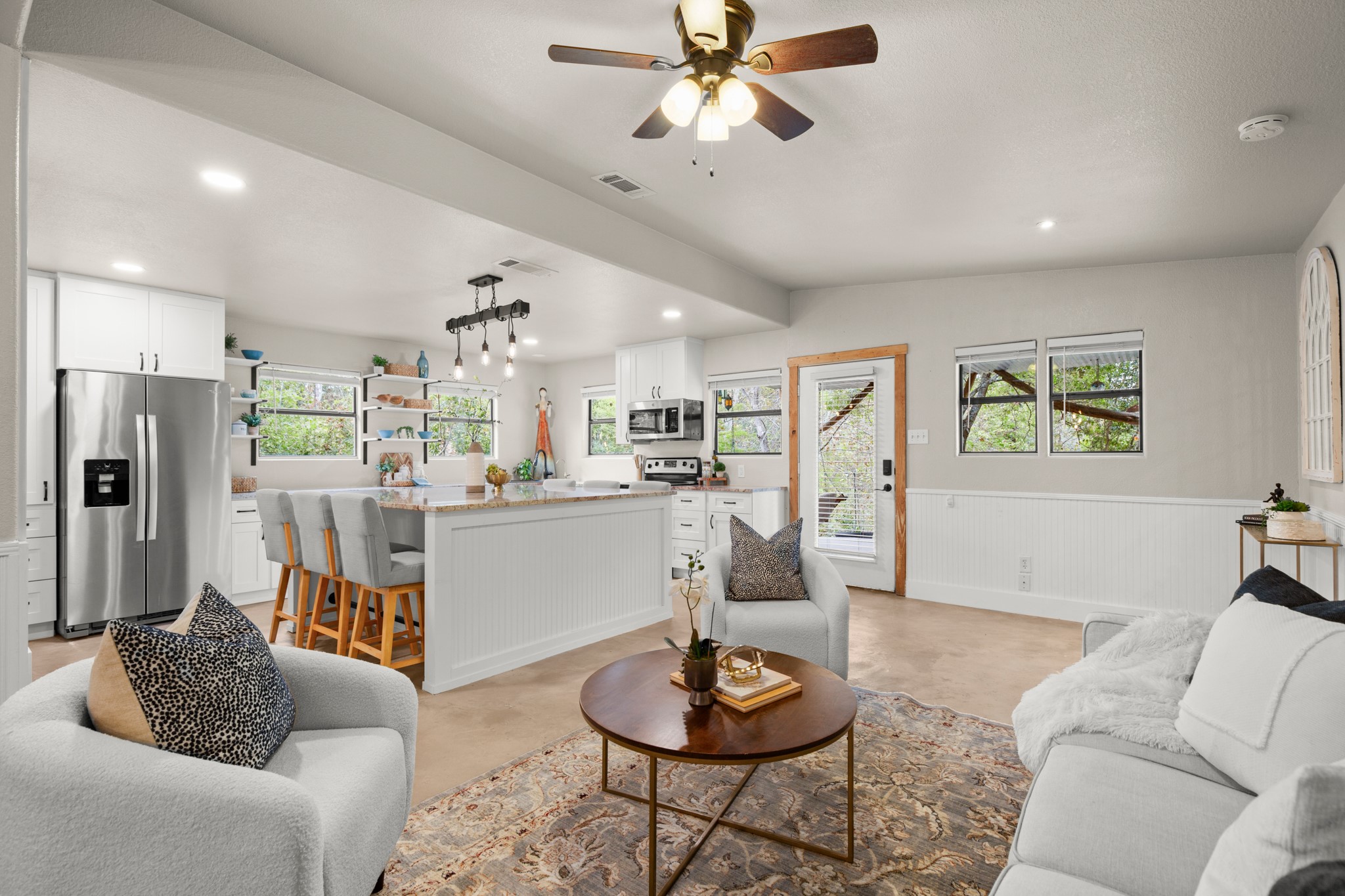 235 Smith Creek Road Wimberley, TX 78676 - Photo 5 of 40 a living room with furniture and a wooden floor