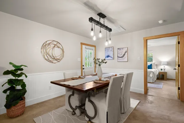 a view of a dining room with furniture and a chandelier