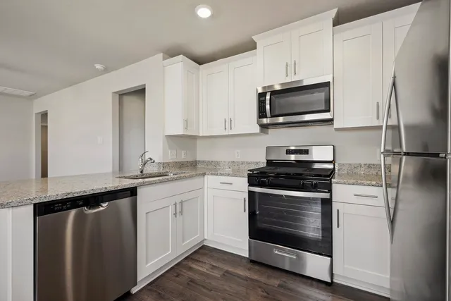 a kitchen with a sink stove and microwave