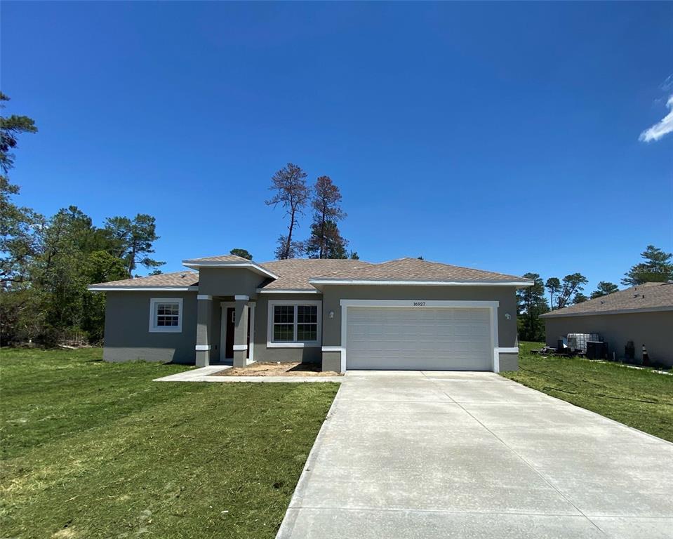 16927 Southwest 25th Terrace Road Ocala, FL 34473 - Photo 1 of 1 a front view of a house with a yard